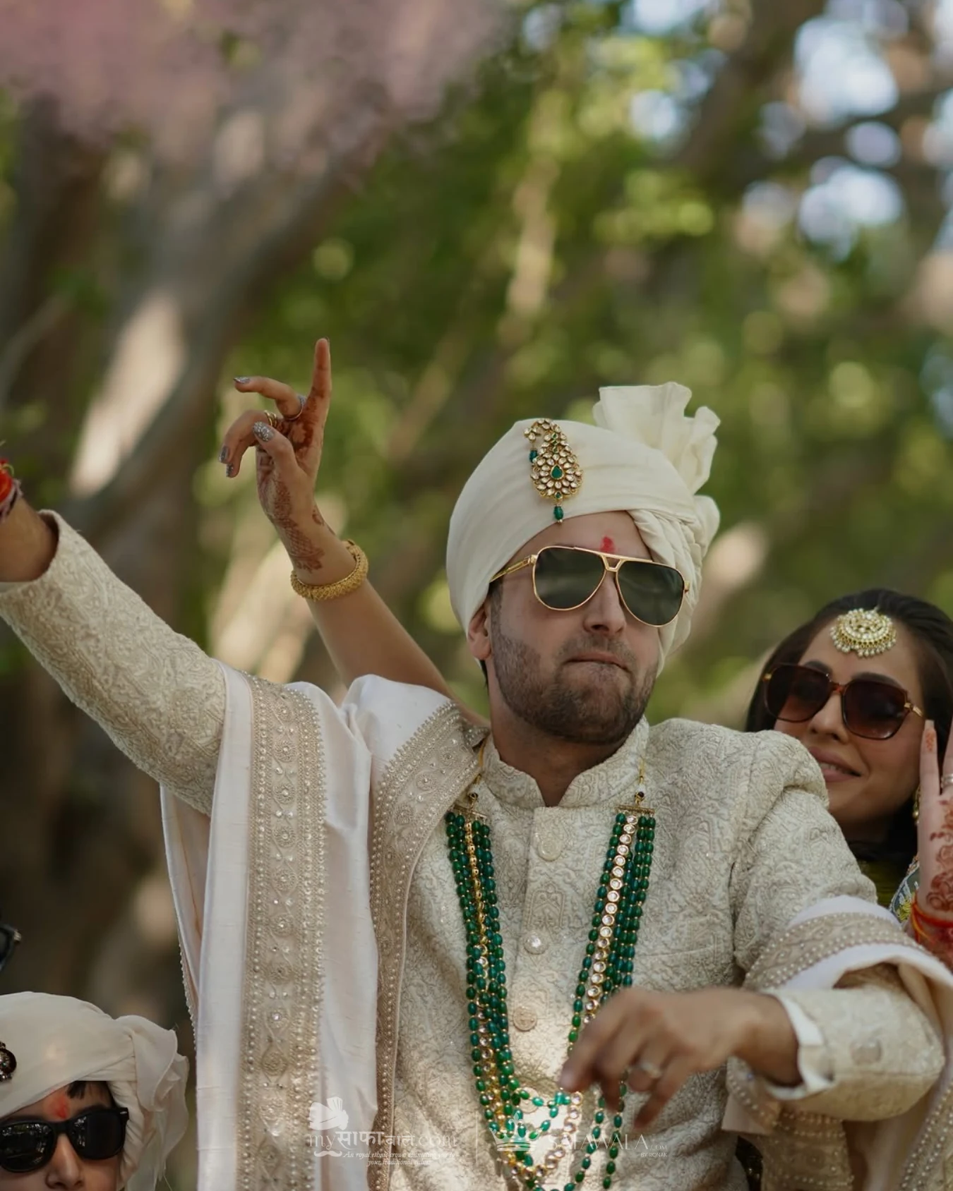 Groom in an ivory wedding safa with emerald jewellery for bulk pagri package in Dharamshala